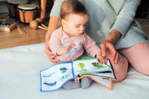 Make Money Selling Children's Toys Online - Baby Reading A Book